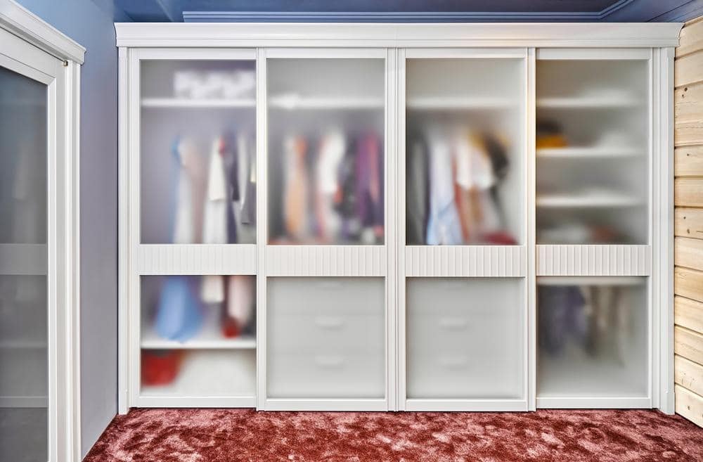 Wardrobe with inserted glass on its door