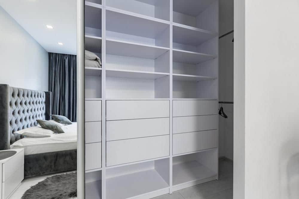 White custom closet with divided shelves and drawers