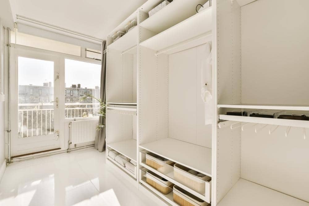 Empty white built in closet in a small room