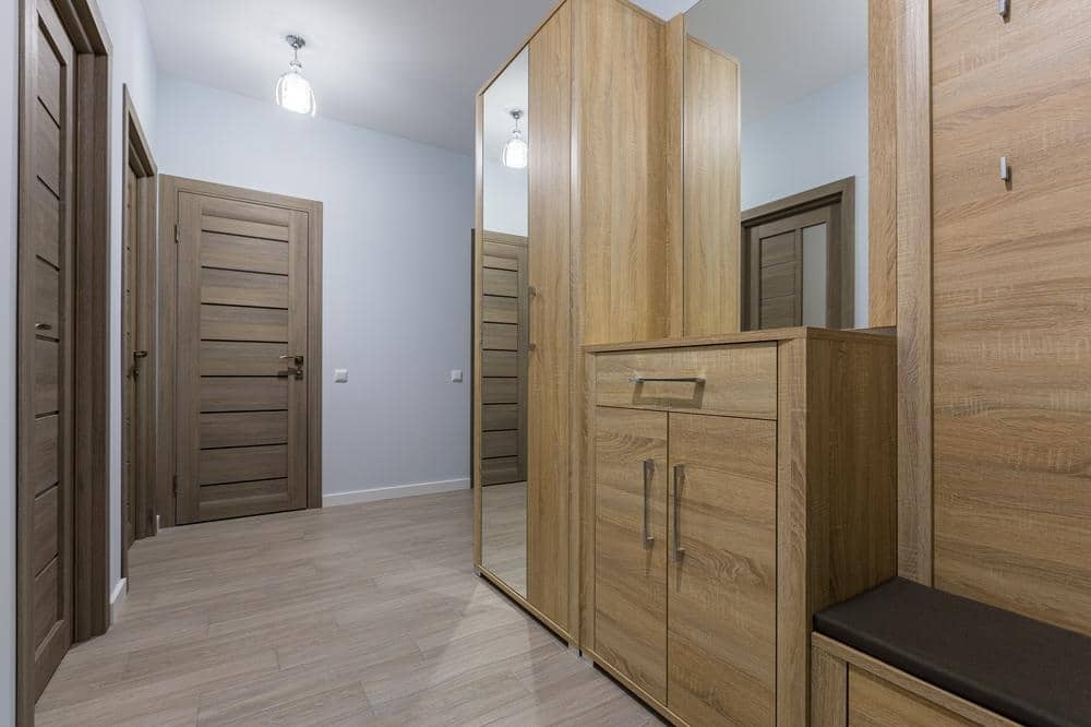 Narrow entryway with wooden closets