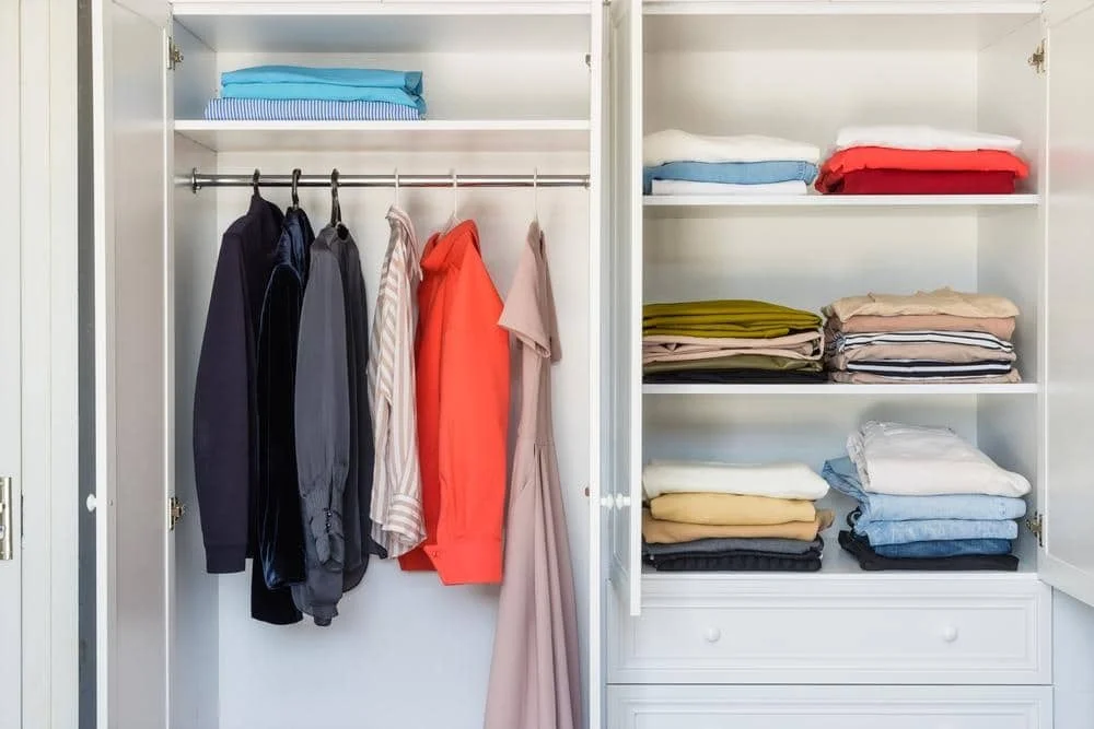 Mastering The Art of Organizing a Walk-In Closet: A Comprehensive Guide 4 Shelves with colorful clothes white wardrobe closeup minimalism style | mastering the art of organizing a walk-in closet: a comprehensive guide